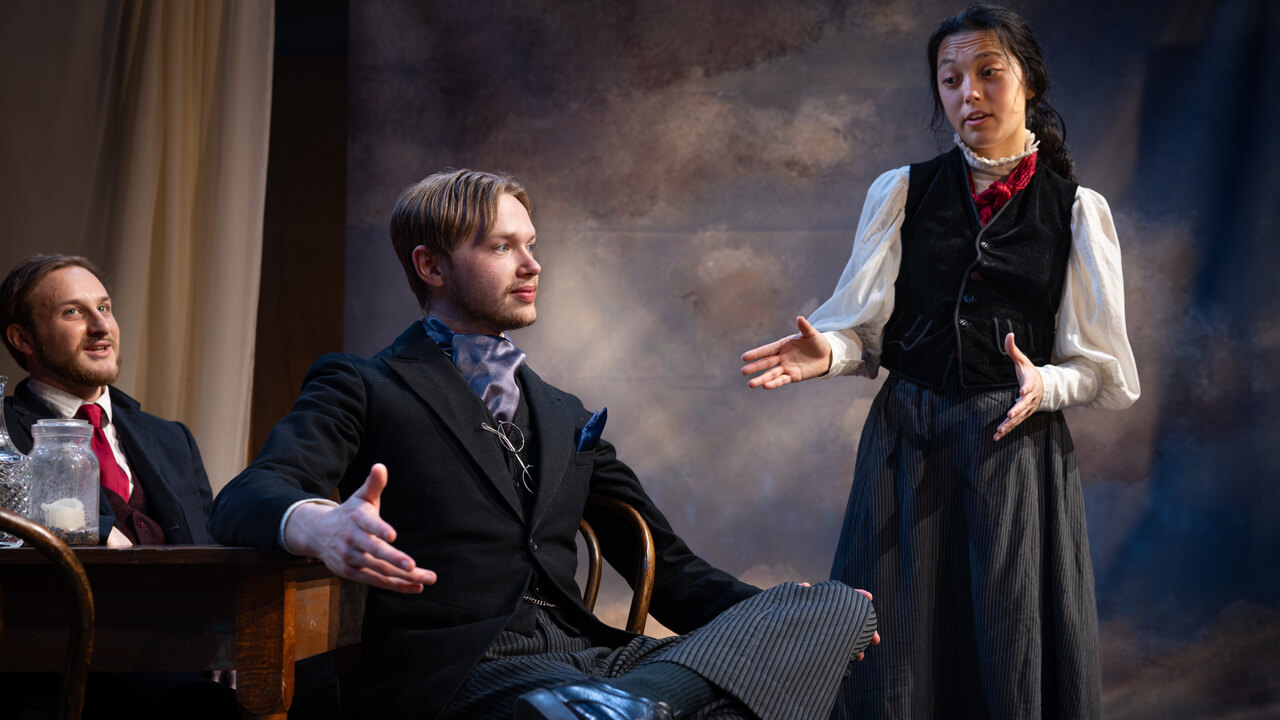 Quinnipiac Theater students acting out a discussion during a live production.