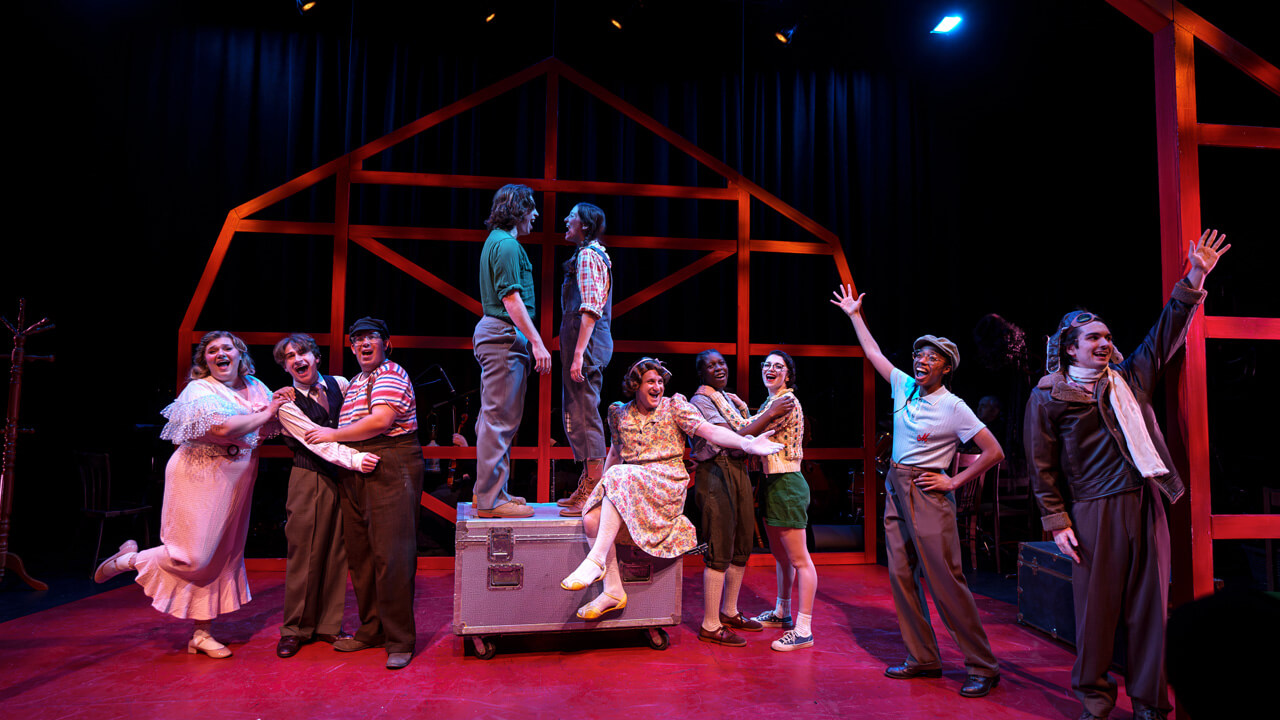 the full cast in the middle of a musical preformance