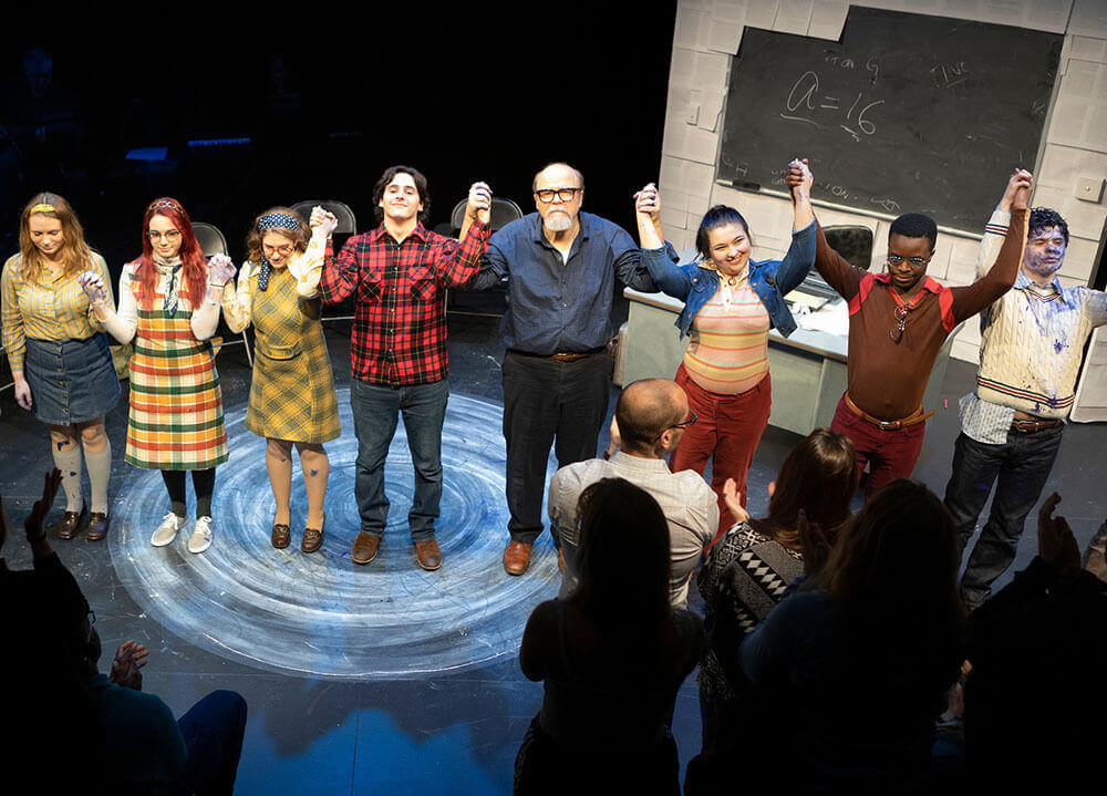 The cast of the theater production of "Rage" hold hands together before bowing to the audience